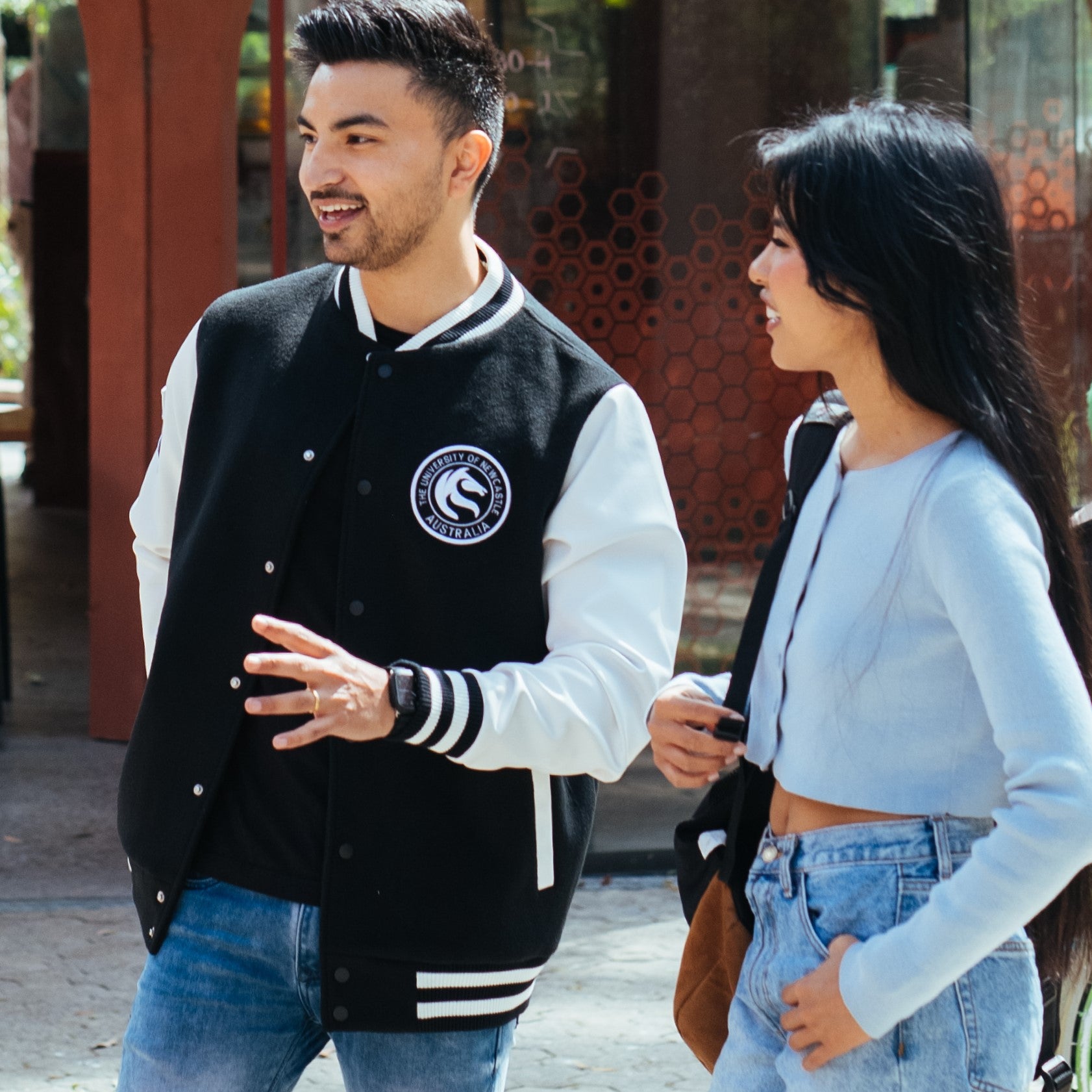 Black varsity jacket with white sleeves and seahorse badge